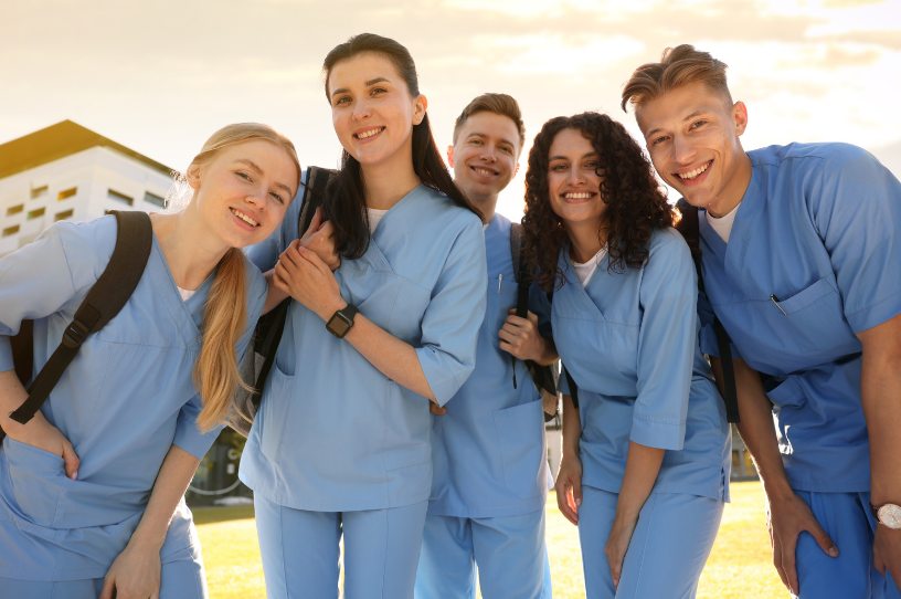 Diverse group of travel nurses smiling together outdoors